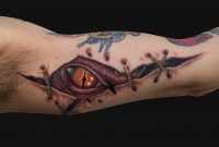 Awesome Ripped Skin Dragon Eye Tattoo On Man Left Bicep for measurements 888 X 888