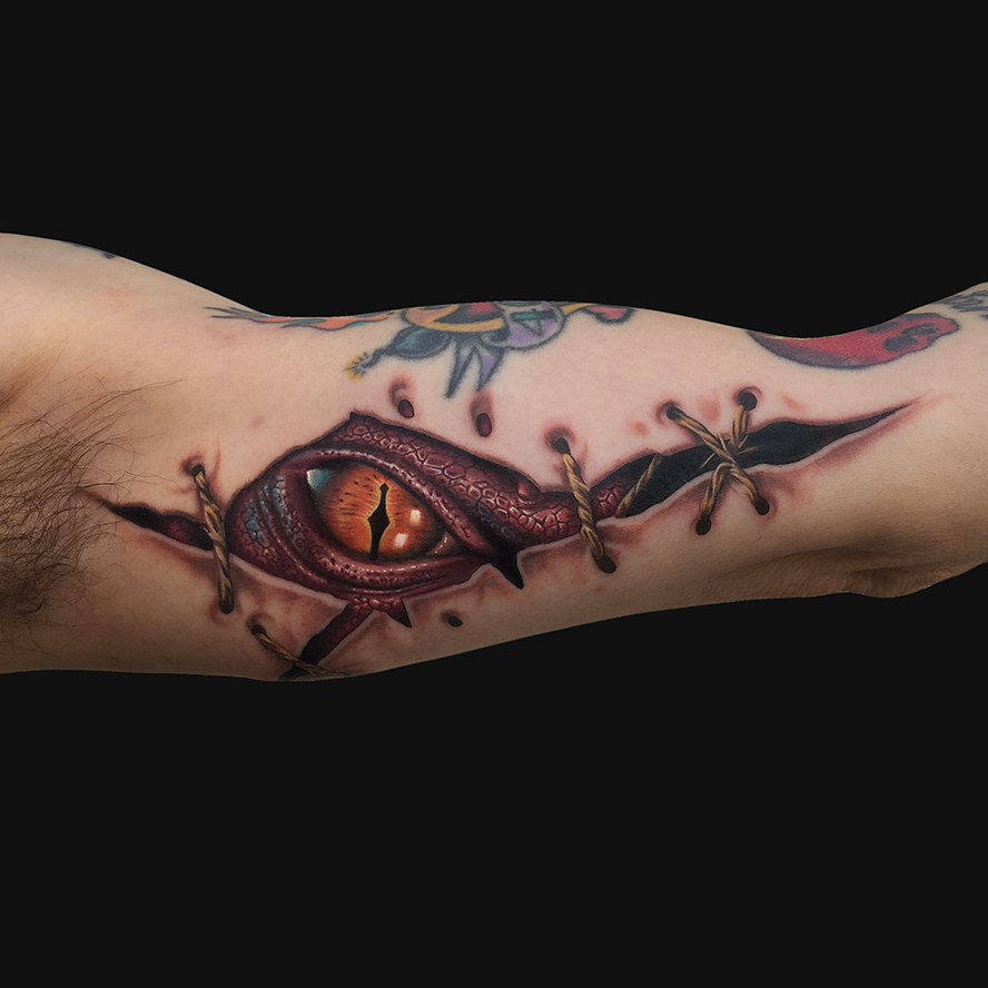 Awesome Ripped Skin Dragon Eye Tattoo On Man Left Bicep for measurements 888 X 888