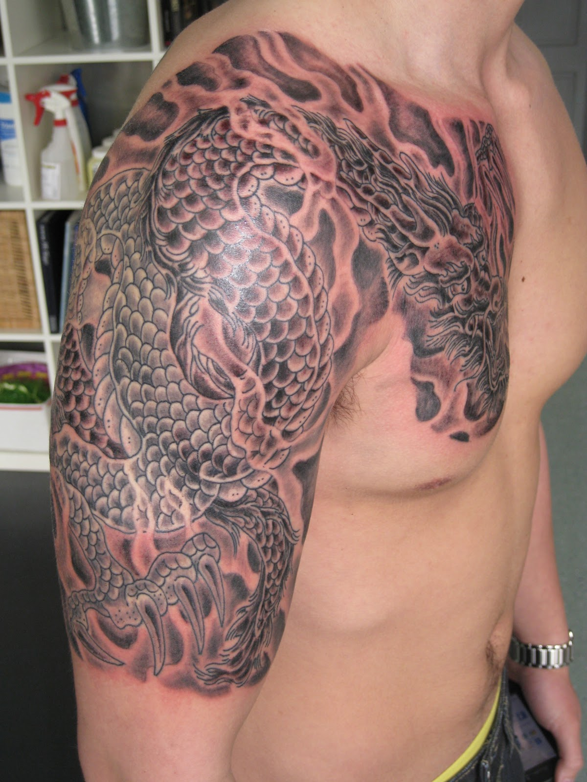 Grey Ink Dragon Tattoo On Chest And Shoulder for size 1200 X 1600