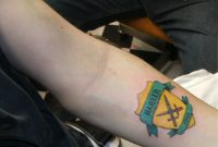Yellow And Green Ink Family Crest Tattoo On Left Forearm regarding dimensions 1280 X 930