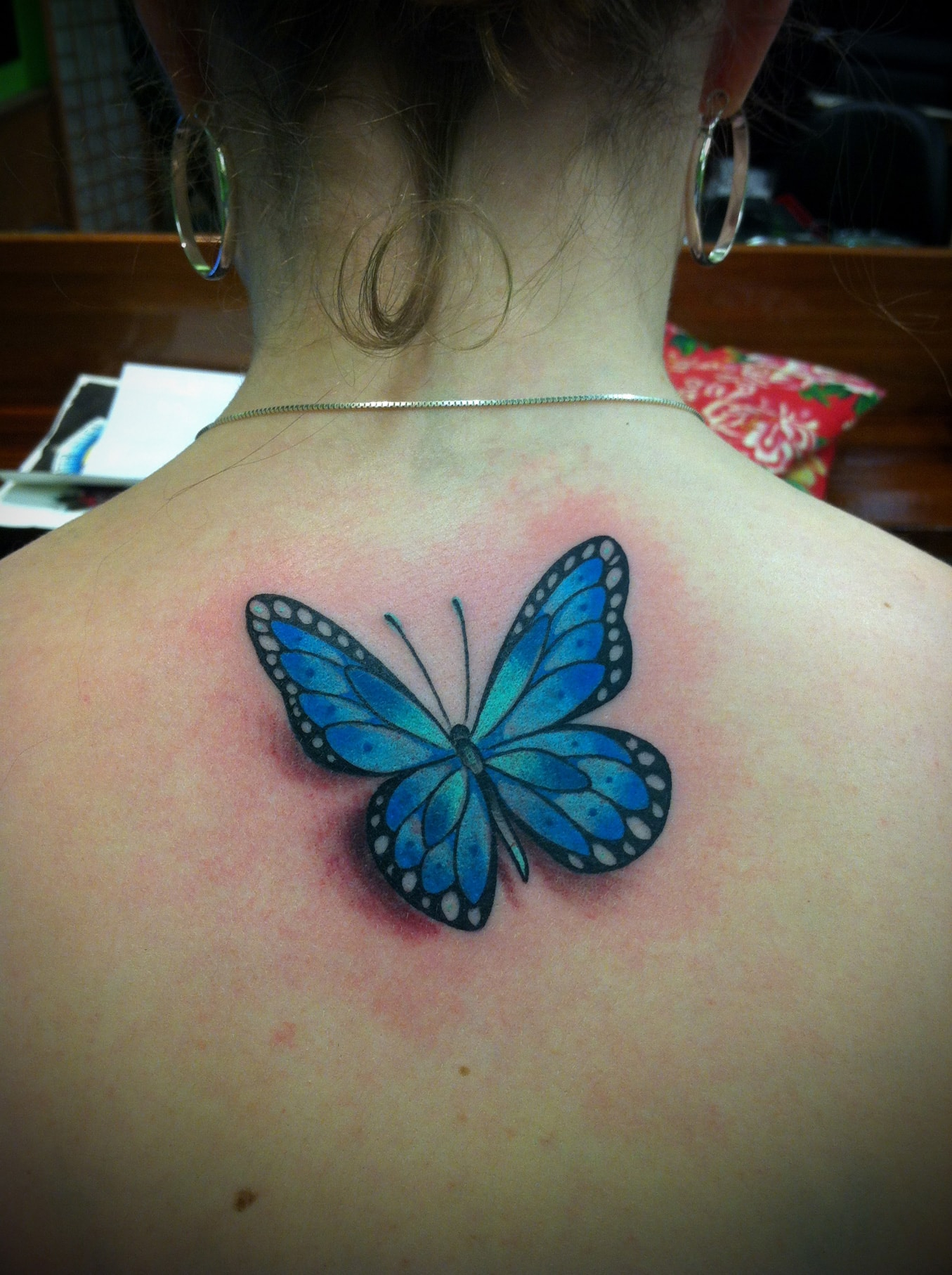 Blue Ink Butterfly Tattoo On Girl Upper Back inside size 1355 X 1814