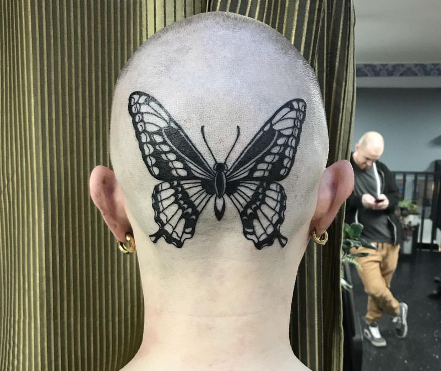Татуировка бабочки на затылке